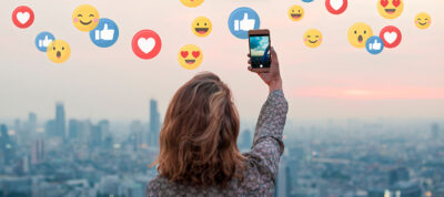 Woman taking photo with her iPhone and getting social media likes